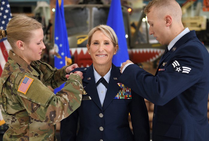 Cadet Tori Flarity and Senior Airman Patrick Flarity pin stars on their newly promoted mother, Brig. Gen. Kathleen Flarity, mobilization assistant to the command surgeon, Air Mobility Command. Farity discusses setting goals and how to achieve them.