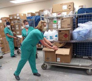 UCHealth's Shauna Sutton, associate operating room nurse manager, helps move donated medical supplies bound for India. Photo by UCHealth