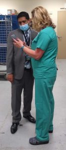 Shauna Sutton confers with Dr. Saketh Guntupalli. Donated medical supplies from UCH will aid a large city in India where Guntupalli’s cousin is a neurosurgeon helping to care for people battling COVID-19. Photo by UCHealth