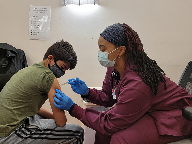 kids get COVID-19 vaccines. Tarek Murad, 12, of Pueblo gets his vaccine in Colorado Springs.