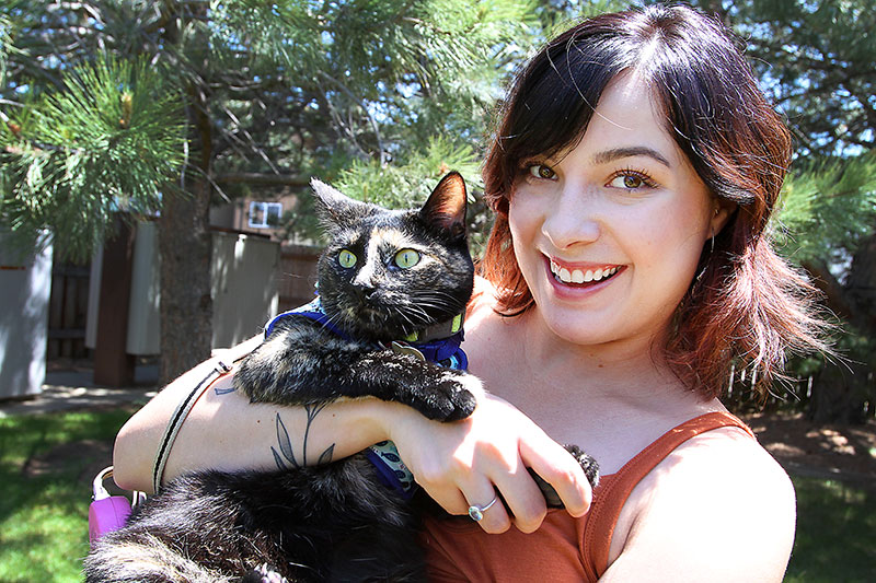 Audrey Lopez with her cat, Calla, who she sometimes walks in the yard as a way for Audrey to help with her recovery of guillain barre. Blood donations saved her life from the effects of the rare immune disorder. Photo by Joel Blocker, for UCHealth.