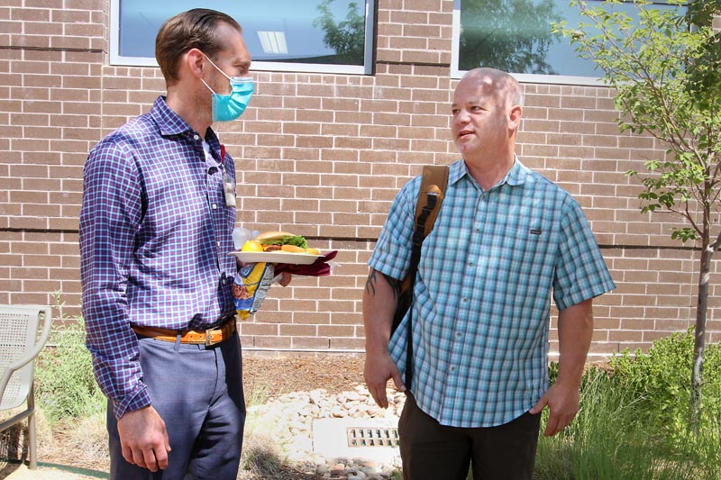 John Larson, right, Jacob's father, talks with Dr. Robert Janata, pulmonologist and critical care physician.