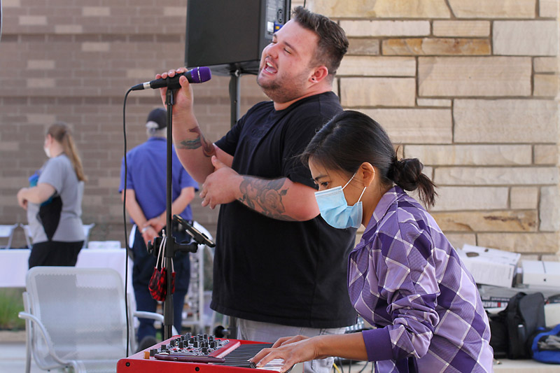 Soul and funk singer Jacob Larson, accompanied by pianist Olivia Rebolledo, sing for health care workers at Longs Peak Hospital in late August.