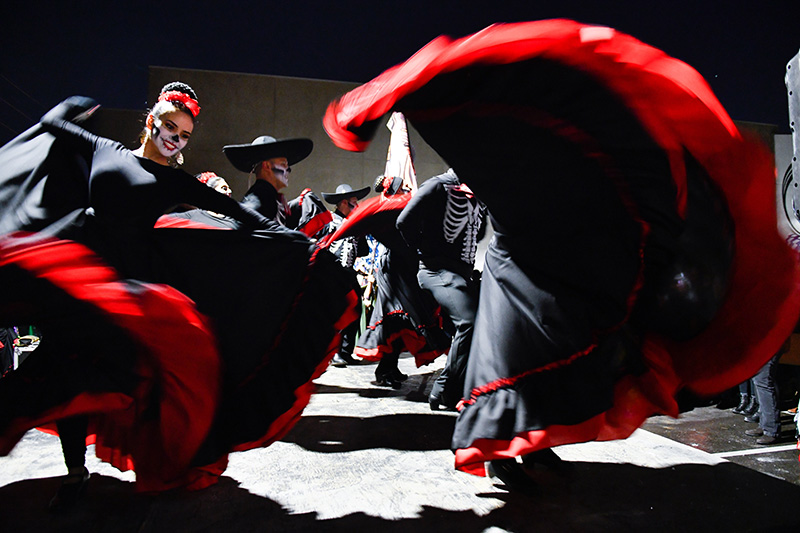 Dancing is common in Day of the Dead parades.