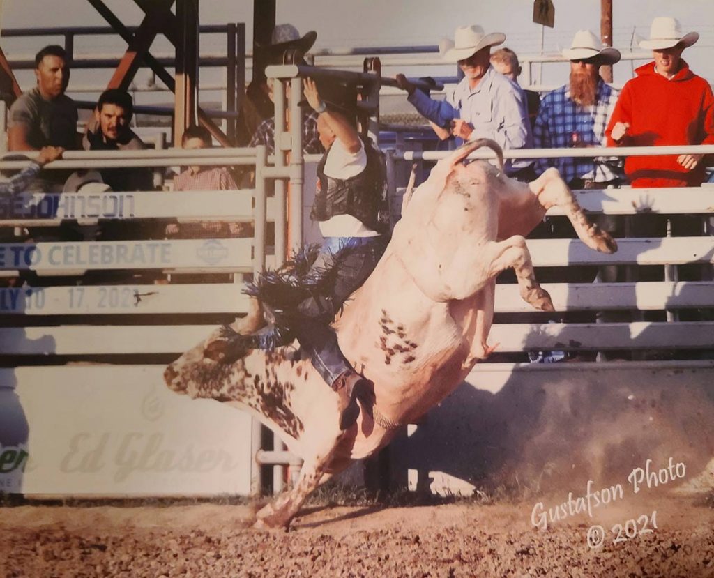 Bull rider Bret Vaugh, who had a heart attack after a ride, on a bull that has kicked up its back legs.