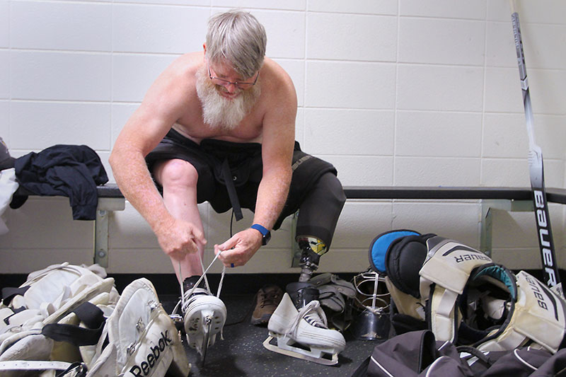 Dennis getting his hockey gear on.