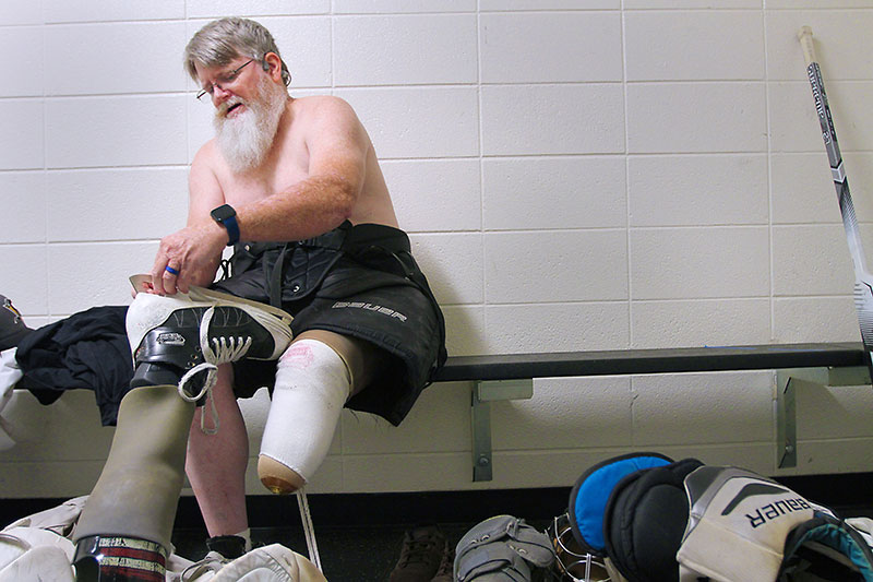Dennis getting his hockey gear on.