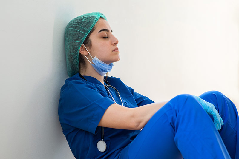An exhausted health care worker closes her eyes. Researchers on the Anschutz Medical Campus are trying to learn more about whether technology can play a role in helping with sleep by enrolling health care providers in a sleep trial.