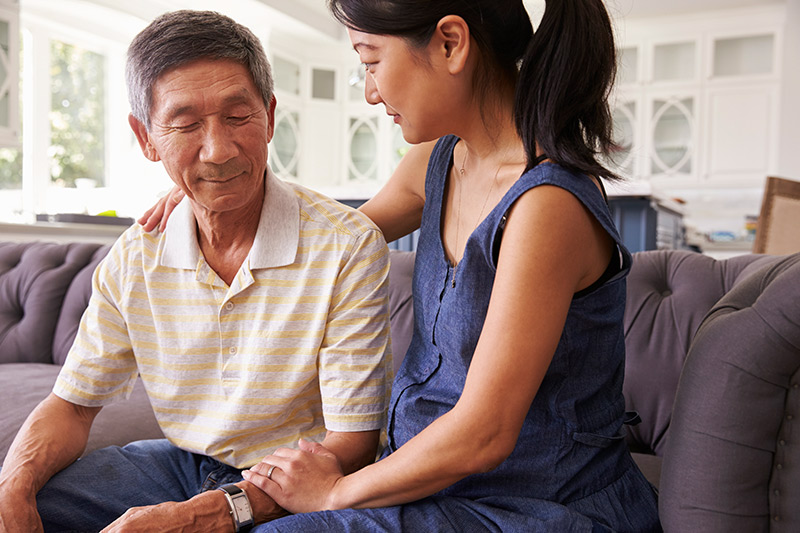 caregiver showing concerns about memory loss in aging man.