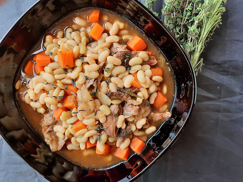 Practice how to use a chef's knife by making braised lamb with beans.