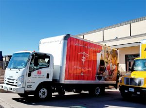 A Project C.U.R.E. truck loaded with medical supplies leaves a UCHealth warehouse in Colorado Springs. Photo: Cary Vogrin, UCHealth.