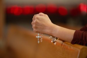 Anna holding a rosary that was a gift her daughter brought home from Rome.