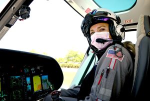 Samantha Poirer, a LifeLine pilot, at the controls of a UCHealth medical transport helicopter.