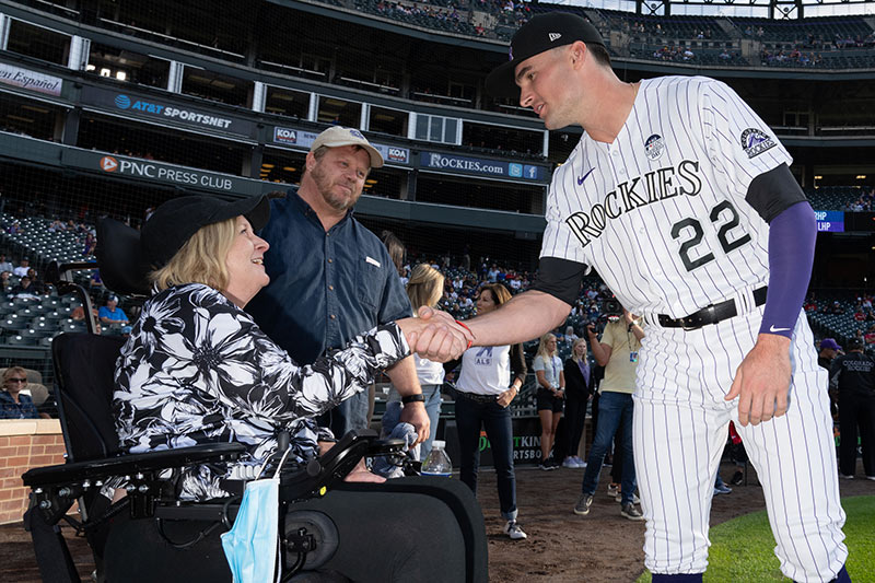 Christine Gilmore with her husband, Chris, and Colorado Rockie's player, Sam Hilliard at Coors Field on Major League Baseball's Lou Gehrig's Day in June 2022. Hilliard lost his father to ALS.