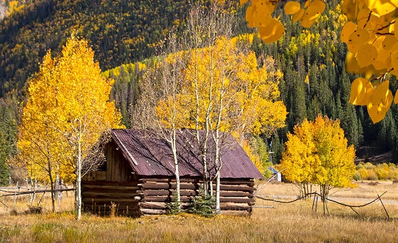 Explore Colorado’s ghost towns while also taking in breathtaking views of the state’s glowing fall colors. Photo: Getty Images.