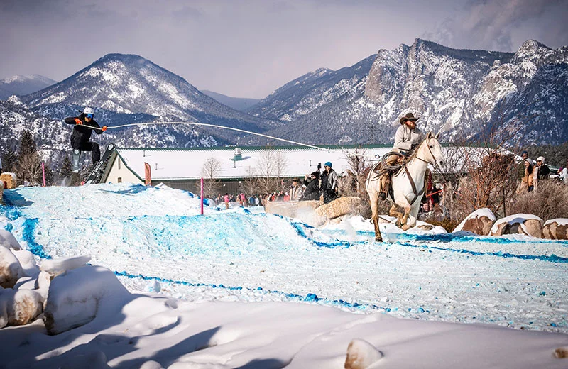 A horse, rider and skier navigate jumps and obstacles during the annual Estes Park Skijor event. Photo courtesy of Visit Estes Park.