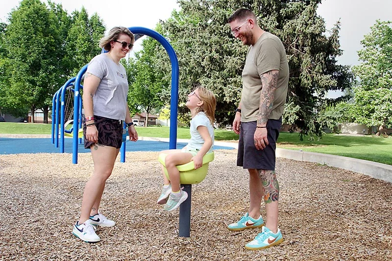Dave, right, and his girlfriend, Holly, play with Dave's daughter, Macy, at their neighborhood park in Greeley, Colorado. Photo by Joel Blocker, for UCHealth.