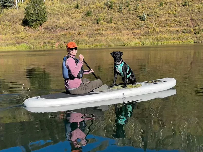 After suffering a deadly heart attack when she was just 40, Kate survived and can lead a full and normal life now. Here, Kate and her dog, Lindy, enjoyed paddelboarding in September of 2024 at Sylvan Lake. Photo courtesy of Kate and John.