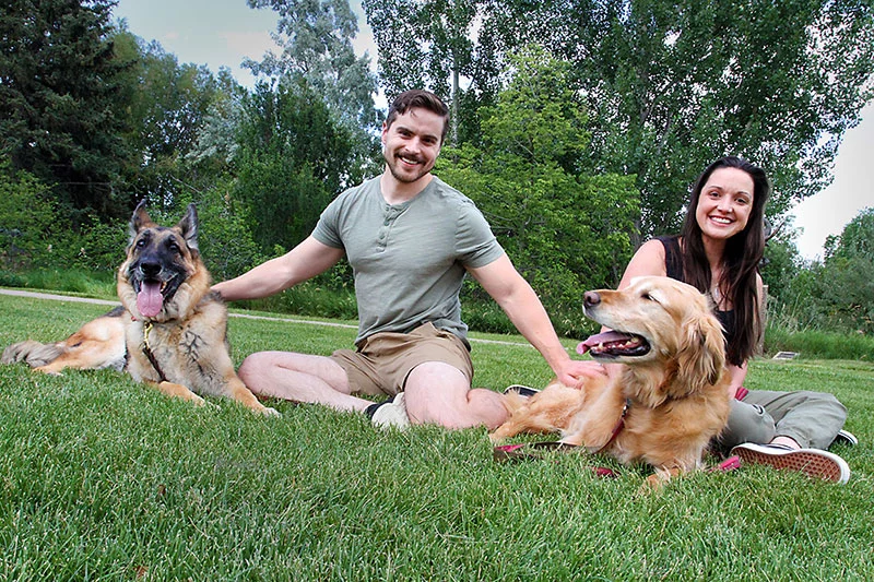 Erica Brown with her husband, Matt Brown, and dogs, Ella and Sinatra, in a park in Loveland, Colorado. Photo by Joel Blocker, for UCHealth.