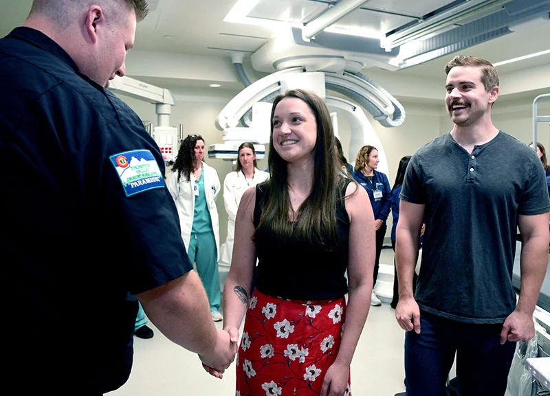 Erica Brown greets Thompson Valley paramedic J Hoffman at a reunion of the Medical Center of the Rockies team involved in her care after a stroke. "Sorry I was sassy with you," she said. Her husband, Matt Brown, recognized the signs of a stroke and immediately called for help. Photo by Sonya Doctorian, UCHealth 