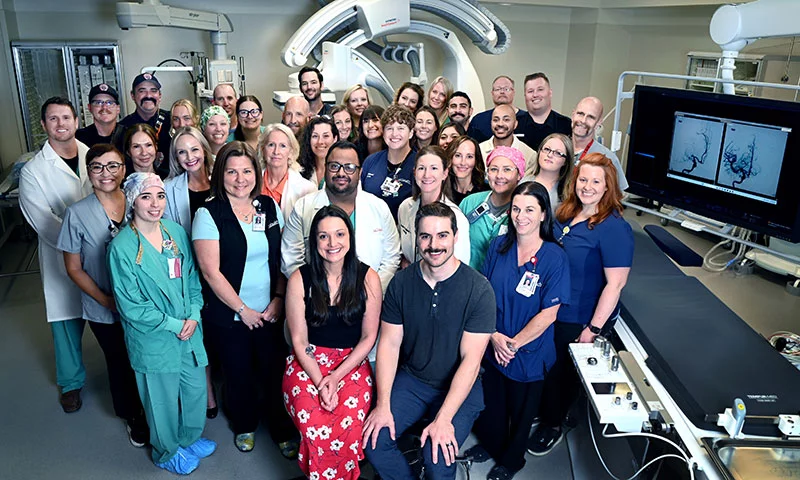 About six months after her stroke, Erica Brown, front left, along with her husband, Matt, front right, gathered with many of the people who cared for her that day, from the emergency responders to her physical therapists. Photo by Sonya Doctorian, UCHealth 