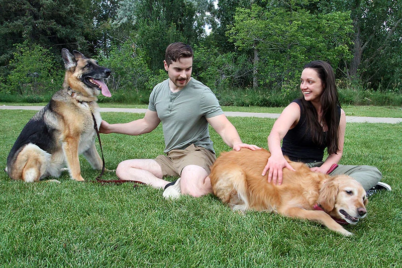 Erica Brown with her husband, Matt Brown, and dogs, Ella and Sinatra, in a park in Loveland, Colorado. Photo by Joel Blocker, for UCHealth.