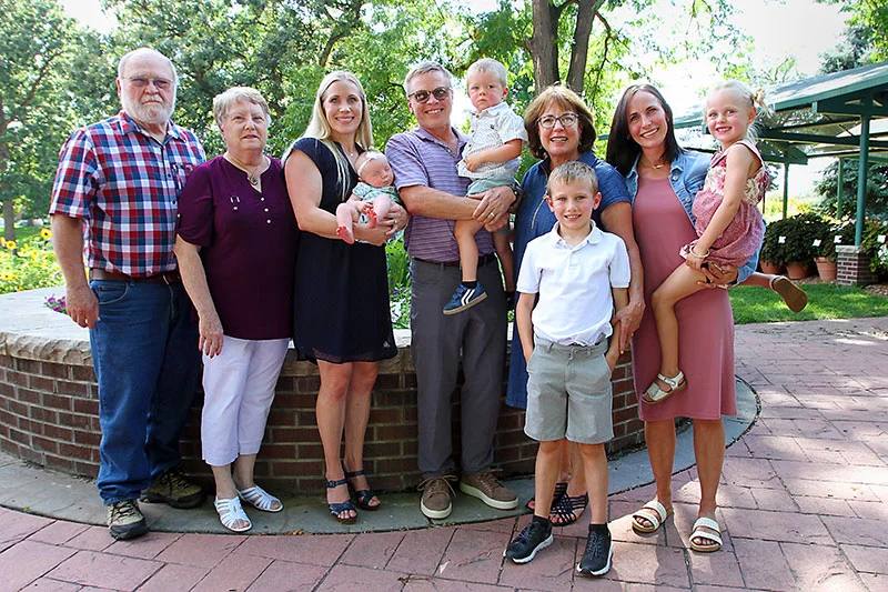 The Delehoy family has welcomed new babies for four generations at what is now UCHealth Poudre Valley Hospital. Family members recently gathered to celebrate their close connection to the hospital as it celebrates its 100th birthday. From left to right, the Delehoy descendants include: Gary Delehoy and wife, Caryn Delehoy; Kirsten Martin, holding her daughter, Adeline, the newest Delehoy descendant, who was born in May of this year; Kevin Follett, holding his grandson, Matthew; Karen Follett, with her grandson, Oliver; and Kelsey Schnoor, with her daughter, Zoë. Aside from Karen and Carlyn, all of the family members were born at Poudre Valley Hospital. Photo by Joel Blocker, for UCHealth.