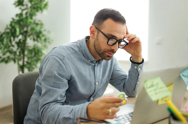 Adult male with ADHD looking at a computer with a fidget spinner in his hand. UCHealth ADHD Skills Group explores how people with ADHD often experience trauma and grief after years of being told they were lazy, undisciplined or unmotivated. And it supports those people by helping them to build executive function skills and hone strategies to counter their inattention issues. Photo: Getty Images.
