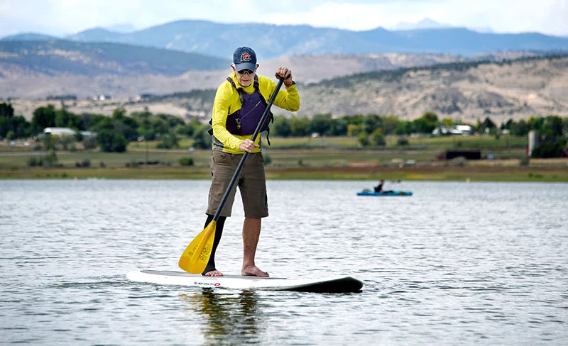 Bob Nicholson paddleboards on McIntosh Lake in Longmont. His UCHealth physical therapist enabled him to maintain his active lifestyle, he says. Photo by Sonya Doctorian, UCHealth.