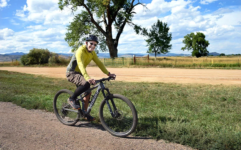 Bob Nicholson wears a compression sock to help manage lymphedema. He trains on his mountain bike on a 5-mile loop around Lagerman Reservoir near Longmont. Photo by Sonya Doctorian, UCHealth