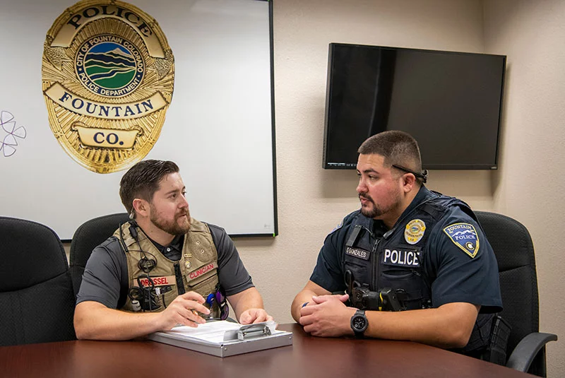 Patrick Drossel, left, and Geno Gonzales. Patrick Drossel, left, a UCHealth licensed professional counselor, works with Geno Gonzales, right, a Fountain Police Department officer. Drossel specializes in providing behavioral health support during police calls. Photo by Chuck Bigger, for UCHealth.