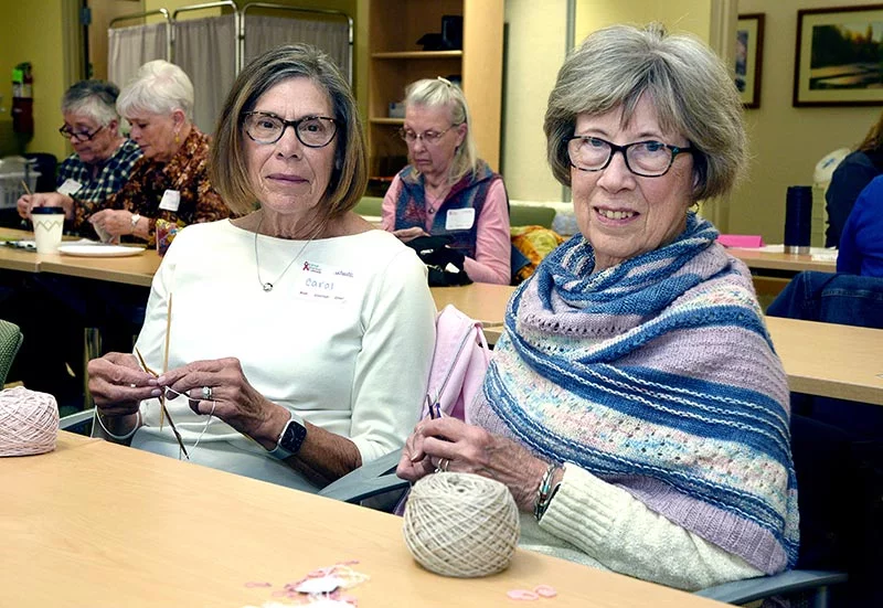 Carol Rieser, left, and Linda Aiken became friends at a knitting retreat five years ago. As breast cancer survivors, they've used their skills several times to create soft prostheses for other women at Knitted Knockers knit-a-thons. After overcoming aggressive breast cancer, Linda is happy to give back at the UCHealth Cancer Center - Harmony Campus, where she was treated 15 years ago. Photo by Sonya Doctorian, UCHealth.