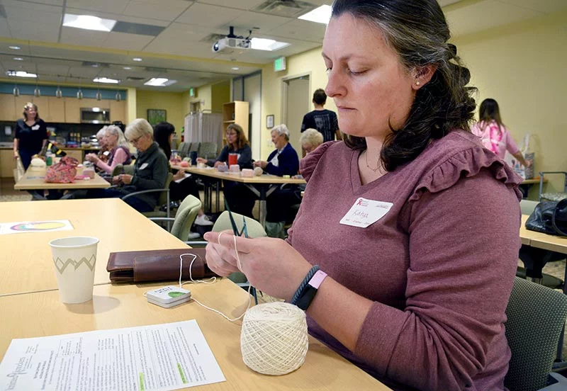 Katya Daragan uses her grandmother's knitting needles for her first knit-a-thon, held Saturday, Oct. 11, at the UCHealth Cancer Center in Fort Collins. Her grandmother was a two-time breast cancer survivor. Photo by Sonya Doctorian, UCHealth.