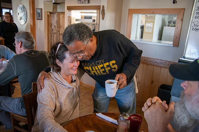Loree Lund and her husband, Chris Lund, talk with Willie Quinney at his business, Silver Cliff Mountain Inn, in Silver Cliff, Colorado. Photo by Chuck Bigger, for UCHealth.