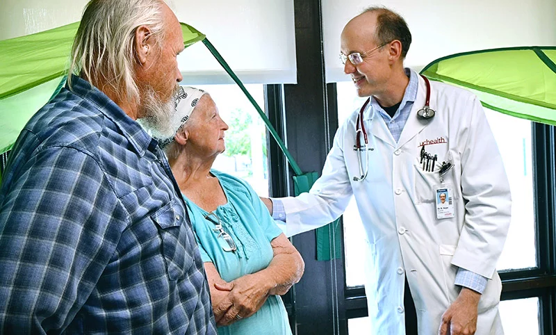 Sherry Jones thanks Dr. Robert Hoyer for leading her through treatment for metastatic melanoma. She and her husband, Richard Jones, drove 80 miles from Cheyenne Wells to Prowers Medical Center in Lamar over the past two years for immunotherapy.  Dr. Hoyer and his oncological outreach team, based in Colorado Springs, stay in local hotels for one week a month to bring cancer care to approximately 130 patients in Lamar and Trinidad. Sherry Jones said, "I would not have continued treatment if I'd had to go to Colorado Springs. It's about 150 miles, one way. And when you don't feel good, that's a long trip." Photo by Sonya Doctorian, UCHealth.