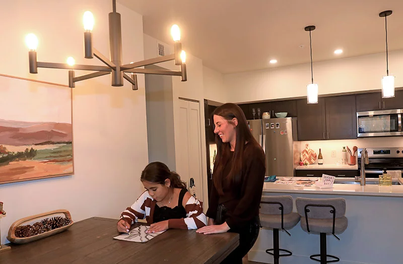 Sydney and Genevieve love the sparkling white kitchen in their apartment. It's easy to get from their apartment to school, the hospital, the grocery store, the ski slopes and Genevieve's grandparents' place. "The stars aligned," Sydney said. Photo by John Russell, for UCHealth.