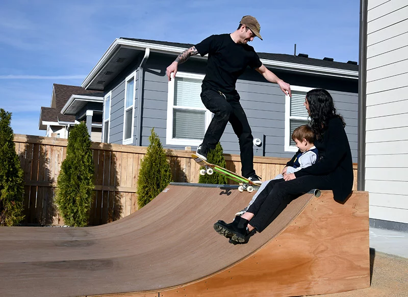 Colin Kiesel enjoys his backyard mini half pipe as Natasha and Will look on. A newly-approved drug, zenocutuzumab, is giving Kiesel hope, who has stage 4 primary pancreatic adenocarcinoma, and has kept him on his board. Photo by Sonya Doctorian, UCHealth.
