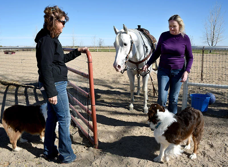 Leslie Woolery opens the gate for Carey and Johnny Ringo MMR after their ride. Leslie met Carey 35 years ago at a horse show when Carey was 13 and her husband, Brent, trained Carey to ride. Photo by Sonya Doctorian, UCHealth.