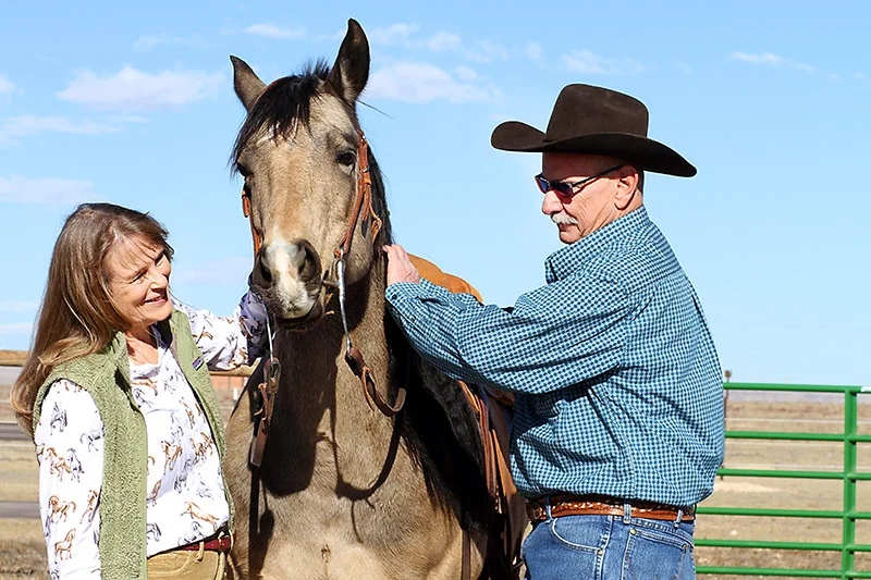 Bob Percival and his horse, Marley, greet Annika Kostrubala, a physician assistant at UCHealth Pulmonology Clinic – Harmony Campus, at Bob's ranch near Carr, Colorado. When Percival first met Kostrubala at the clinic for help with severe COPD, she asked what mattered most to him. Bob's answer: getting back in the saddle with Marley, the horse he once rode in ranch-style competitions before COPD took him out of the arena. Photo by Joel Blocker, for UCHealth.