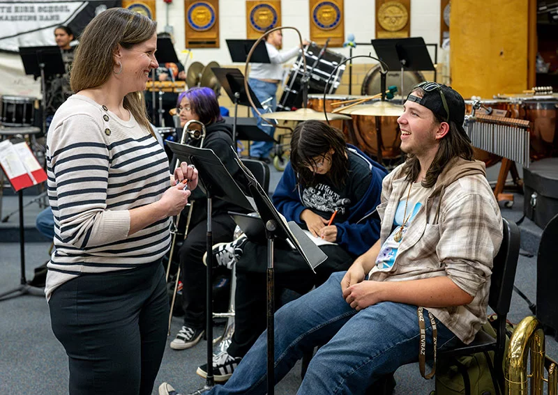 Rachael talks with her son, Reid, who plays baritone at South High School in Pueblo, where she is the band booster club president. Photo by Mike Sweeney, for UCHealth.