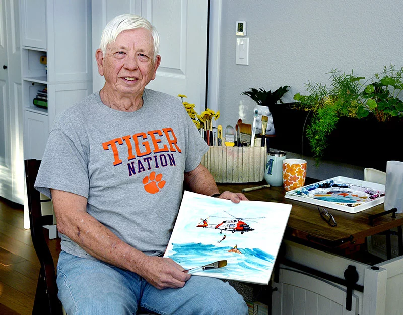 Edgar Schrader painted a U.S. Coast Guard scene in watercolors as a Christmas gift for his grandson, Connor Lowrey. Connor will move to Florida to start his service in January. Photo by Sonya Doctorian, UCHealth.