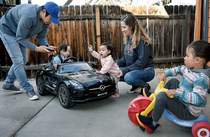 Nhanh sets up the remote control to drive Grayson around the driveway. “We’re just being normal parents,” Nhanh said. “It’s a relief to see progress and growth every day.” Photo by Sonya Doctorian, UCHealth.