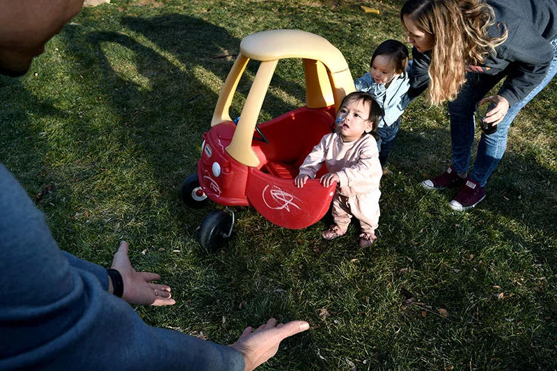 Nhanh encourages Summer to take a few steps as Alyssa supports Grayson, Photo by Sonya Doctorian, UCHealth.