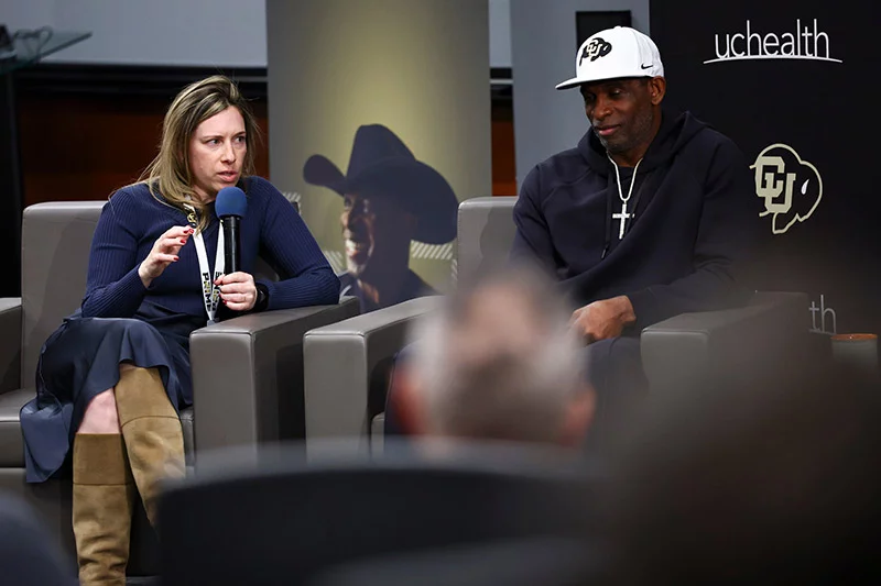 Dr. Janet Kukreja, left, is director of urologic oncology and cares for patients — including Coach Prime — at UCHealth University of Colorado Hospital. Kukreja joined Coach Prime during the December, 2025 event, “Prime Perspective.” She performed Sanders’ radical cystectomy with neobladder, and is one of the top U.S. surgeons performing the procedure. Photo by Taylor Schank, Clarkson Creative Photography, for UCHealth.