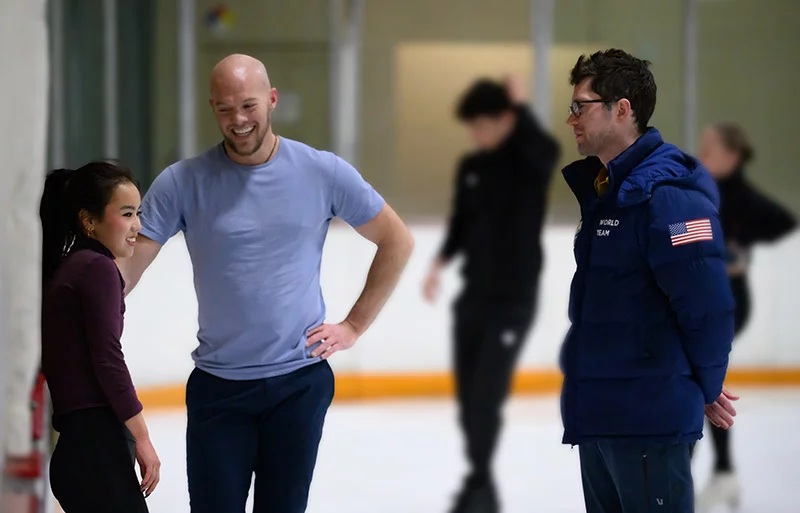 Ellie Kam and Danny O'Shea chatted with their coach, Drew Meekins, during a practice session on Jan. 26, 2026 at the Broadmoor World Arena in Colorado Springs. Photo by Mark Reis, for UCHealth.