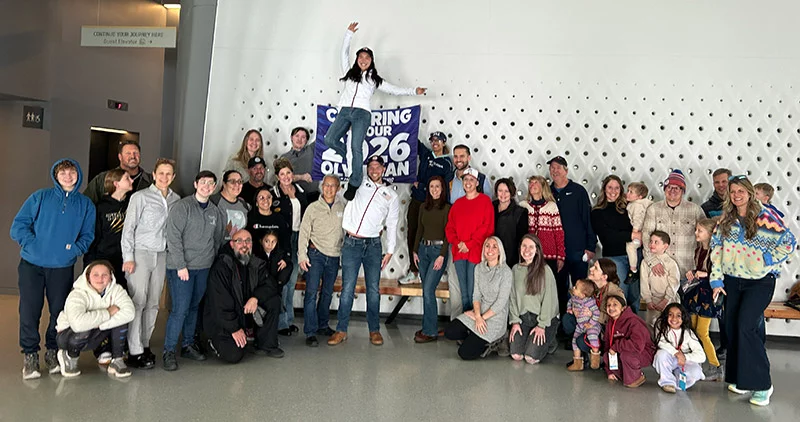 Fans of Ellie Kam and Danny O'Shea gathered for a sendoff celebration at the United States Olympic & Paralympic Museum in Colorado Springs on Jan. 24 to wish Ellie and Danny well. Just as he does on the ice, Danny lifted Ellie high in the air. Photo by Katie Kerwin McCrimmon, UCHealth.