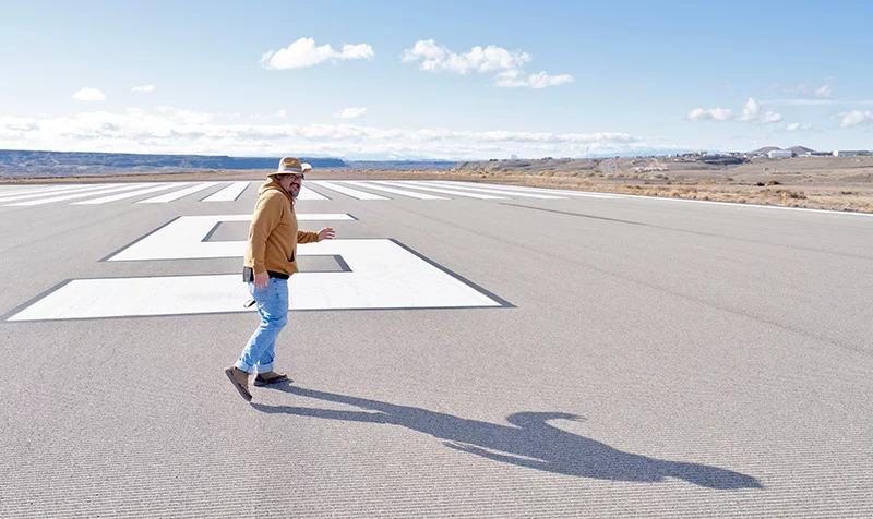 Joseph, on the runway where he works. After his heart transplant at age 35, he now sees this stretch of pavement as a symbol of a new life full of fun possibilities. Photo by Donovan Quintero, for UCHealth.