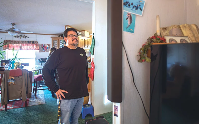Back in his home at last, Joseph looks around with a sense of relief. After months of uncertainty and a heart transplant at 35, he’s grateful to return to the place that grounds him. Photo by Donovan Quintero, for UCHealth.