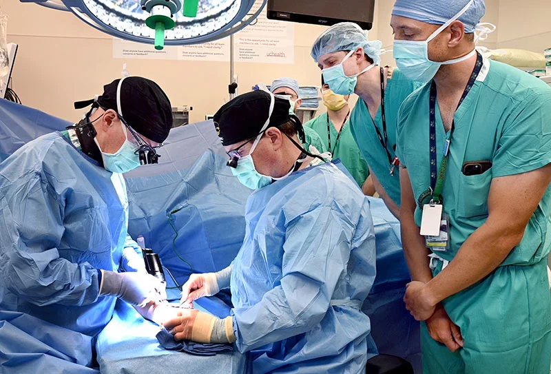 Dr. Louis Catalano, left, and Dr. Fraser Leversedge, chief of hand surgery at UCHealth University of Colorado Hospital, performed a new kind of surgery to help patients with thumb arthritis on Feb. 16. The surgery was the first of its kind in the western U.S. after federal officials approved the new type of prosthesis. Dr. Mark Greyson, center, and Dr. Matthew Belton watched closely before performing surgeries on additional patients on Feb. 16. Photo by Sonya Doctorian, UCHealth.