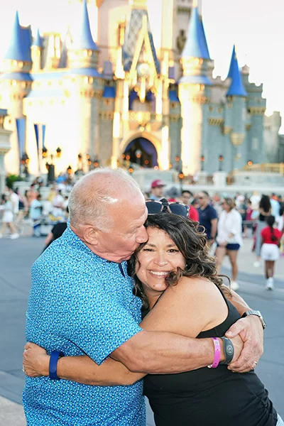 As Mike recovered from his stroke, he hatched a plan to take his family to Disney World. Mike made that dream come true in October. He felt great and logged as many as 18,000 steps a day. Here, Mike hugs his wife and celebrates recovering from his stroke. Photo courtesy of Mike Bukowski.